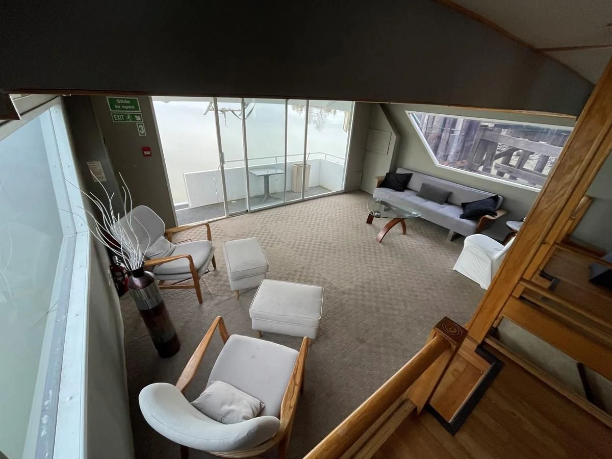 a room with a bed and a table and chairs aboard MAGIC MOMENT Yacht for Sale