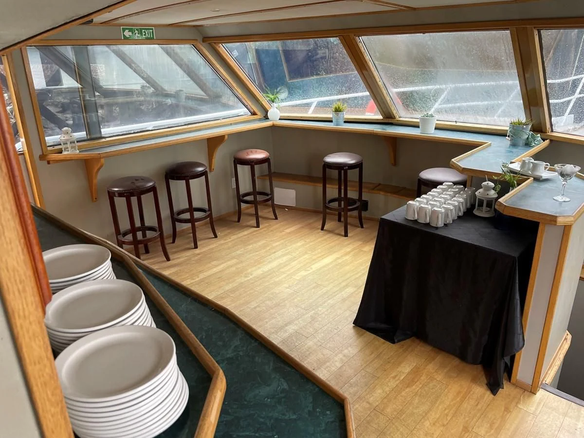 a kitchen with a table and chairs aboard MAGIC MOMENT Yacht for Sale