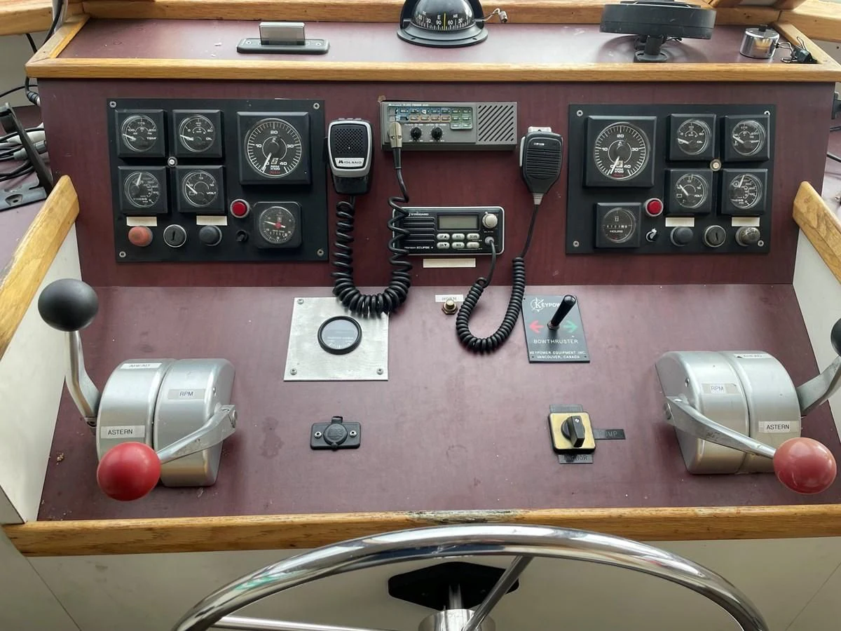 a wooden table with a small radio and other electronics on it aboard MAGIC MOMENT Yacht for Sale