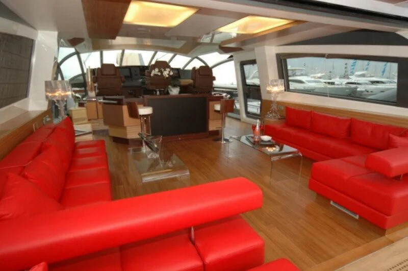 a living room with red couches aboard BLACK LEGEND Yacht for Sale