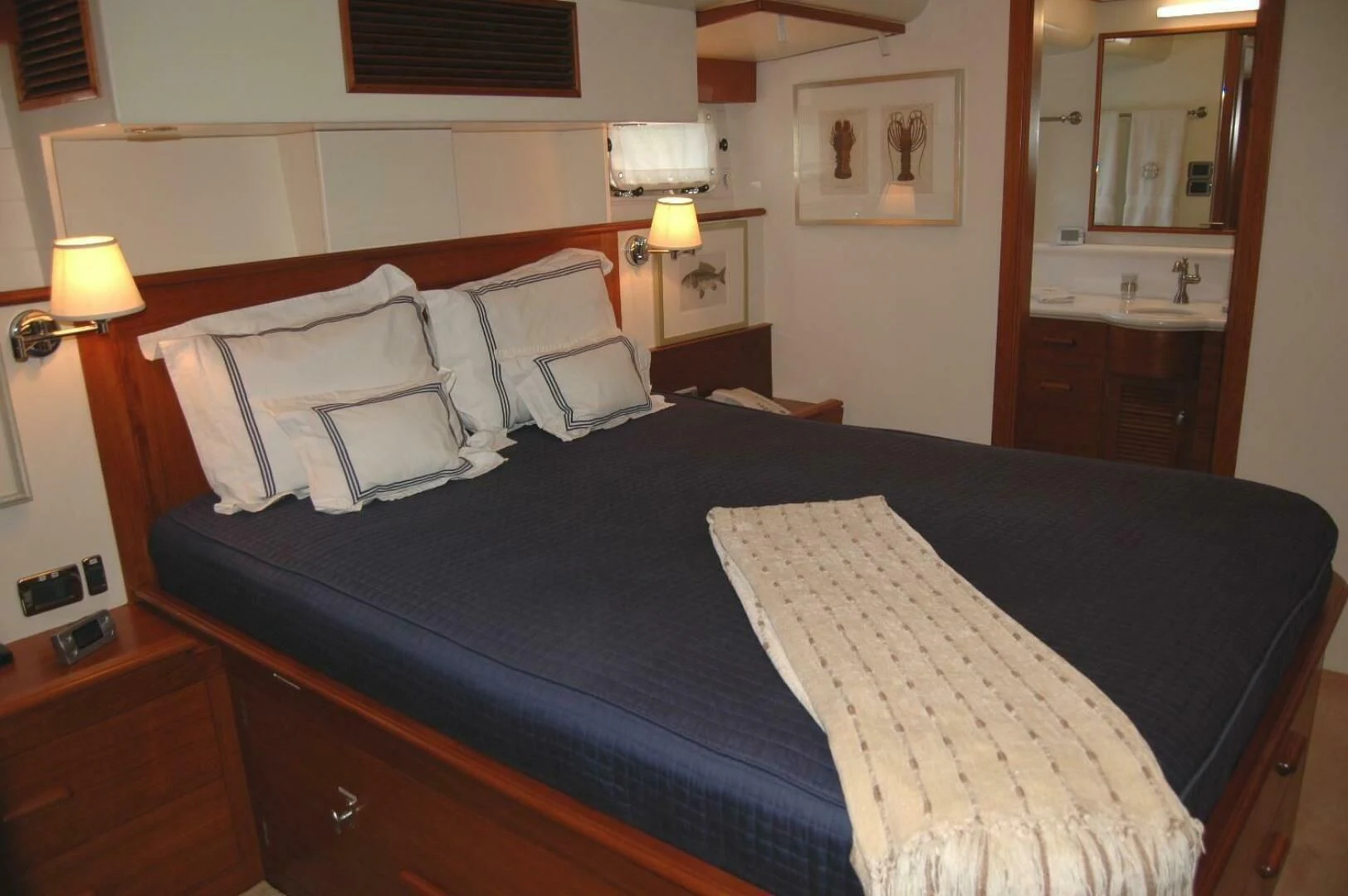 a bed with a blue sheet aboard SEA BOLD Yacht for Sale