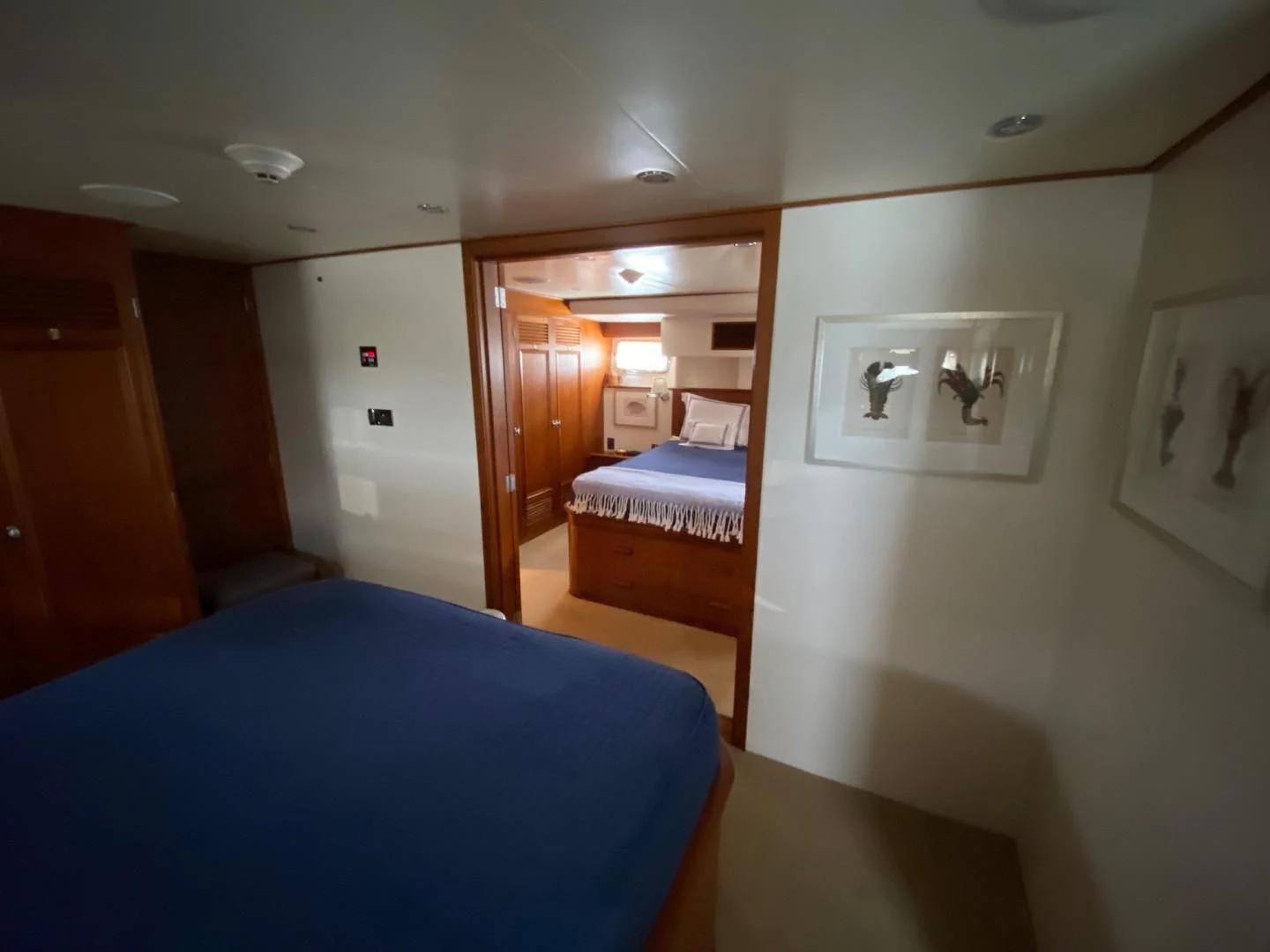 a bedroom with a blue bed aboard SEA BOLD Yacht for Sale