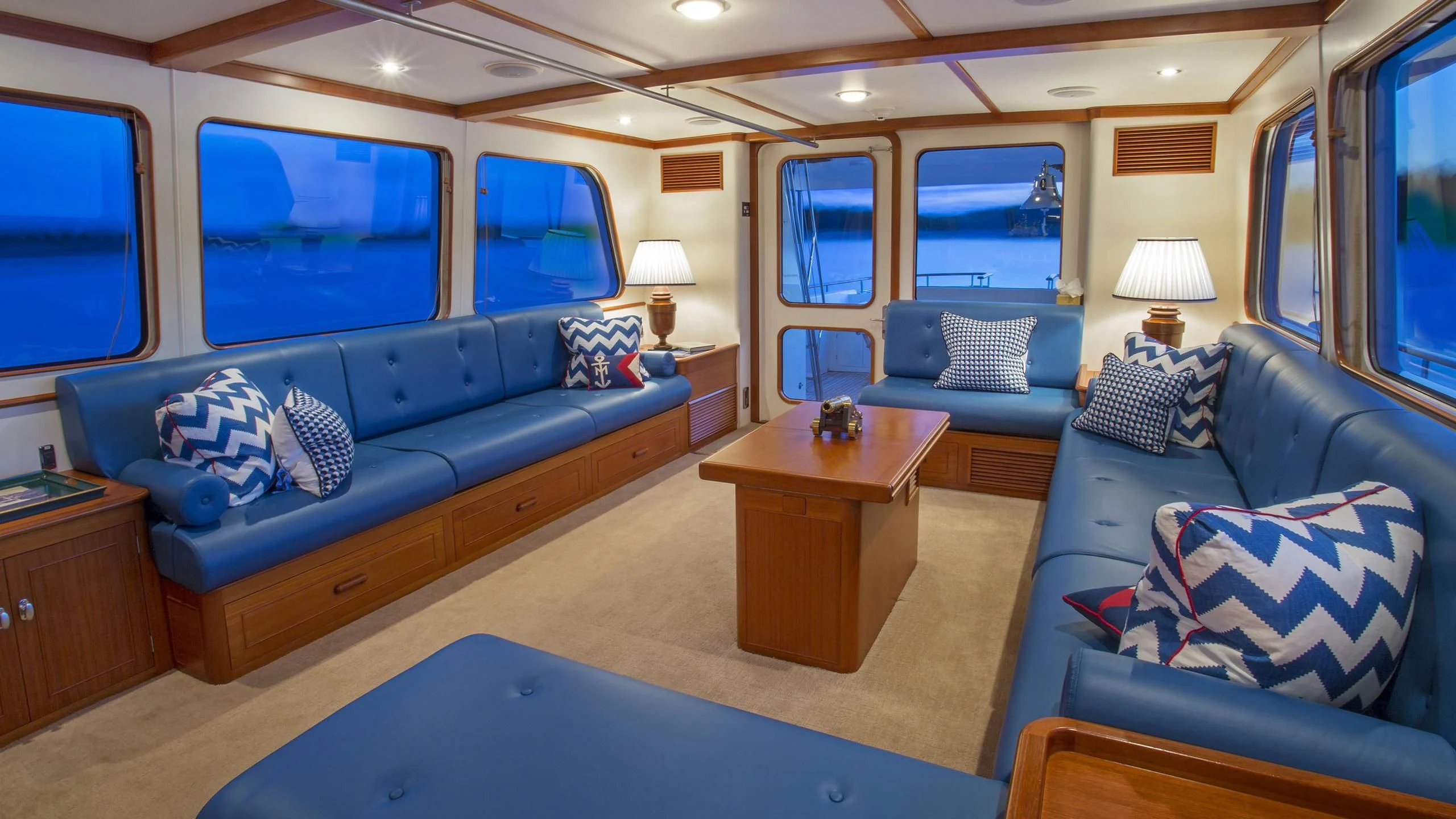 a bedroom with a blue couch and a coffee table aboard SEA BOLD Yacht for Sale
