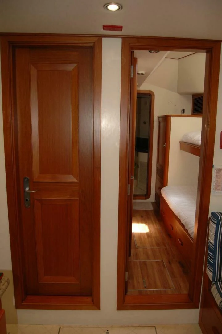 a wooden closet with a door aboard SEA BOLD Yacht for Sale
