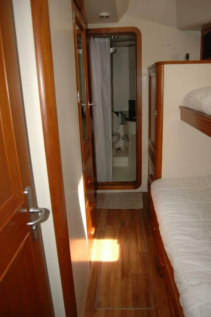 a bedroom with a bed and a closet aboard SEA BOLD Yacht for Sale