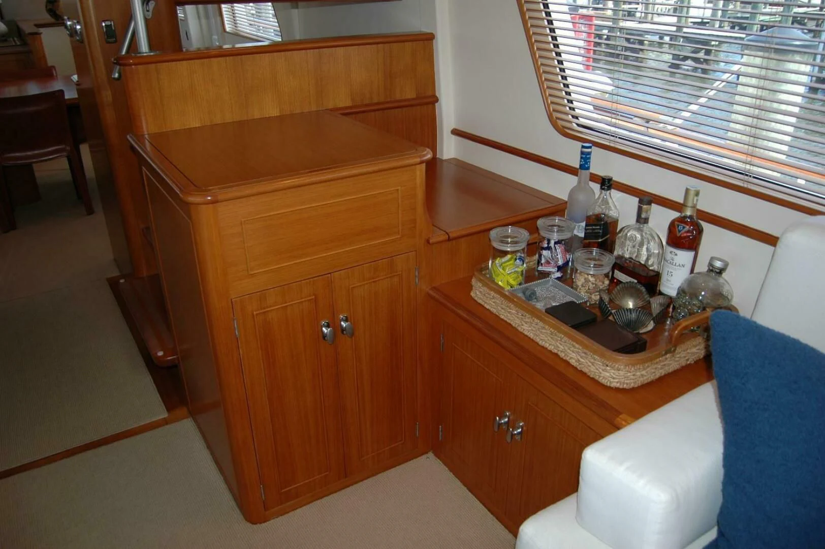 a wooden cabinet with bottles and a tray of food on it aboard SEA BOLD Yacht for Sale