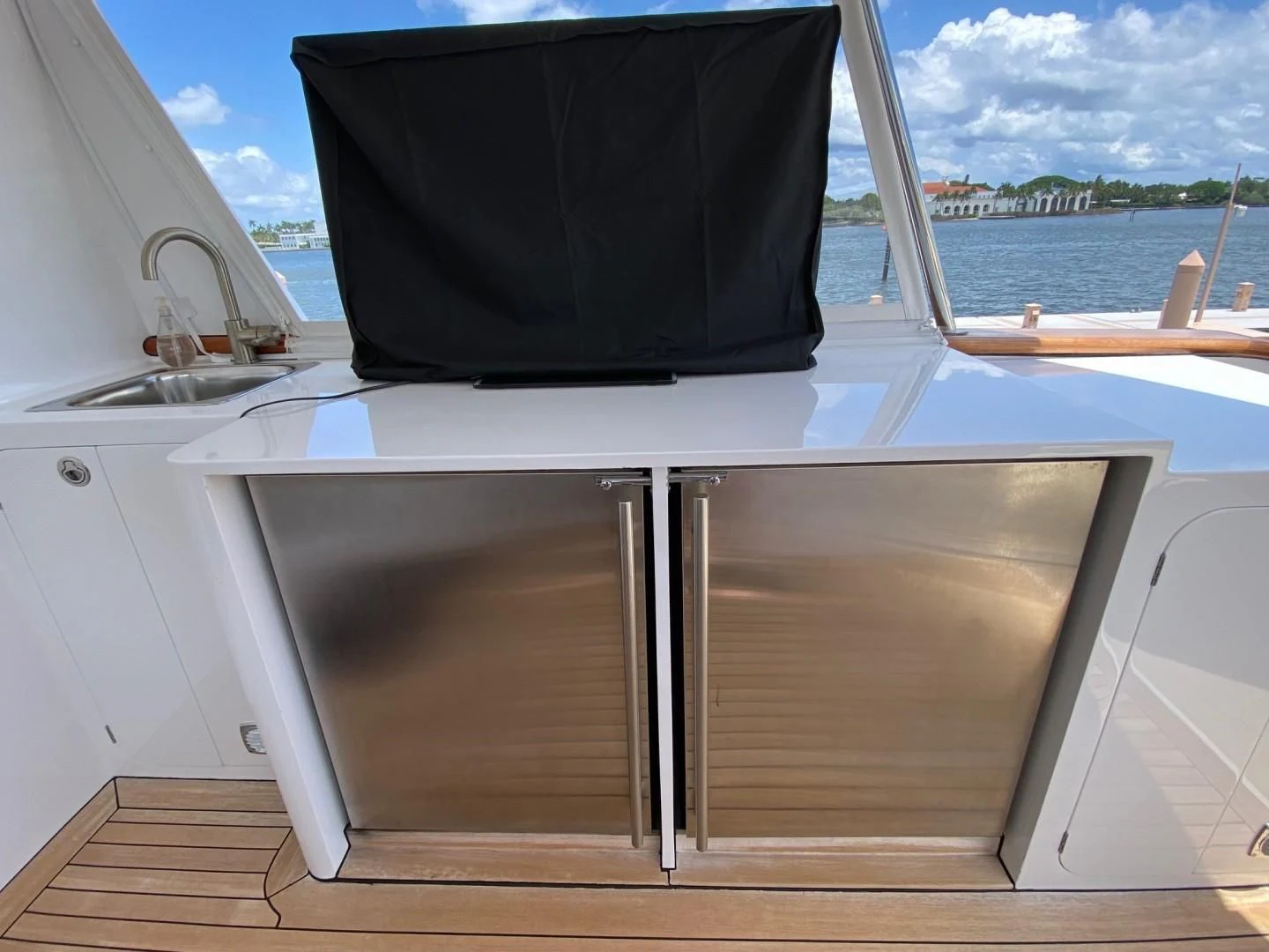 a white rectangular object with a black screen on a wooden surface aboard SEA BOLD Yacht for Sale