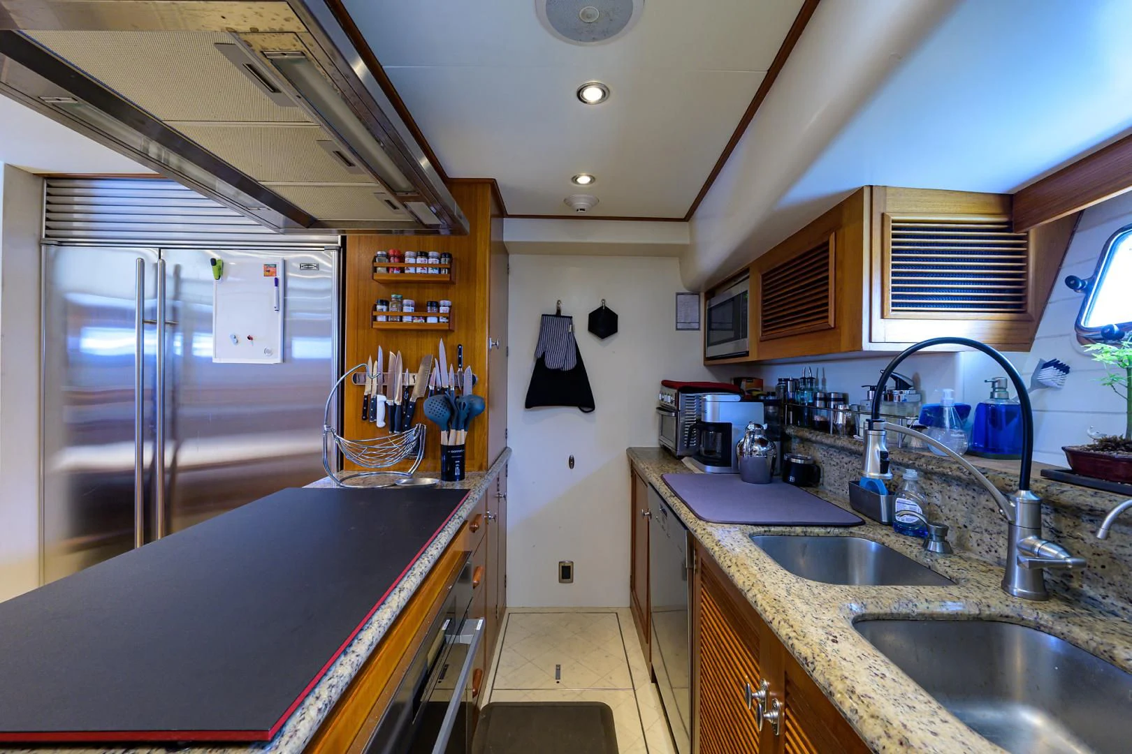 a kitchen with a stainless steel refrigerator aboard SEA BOLD Yacht for Sale
