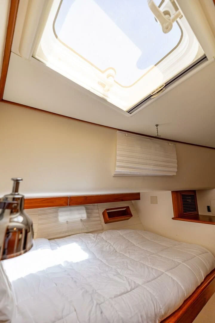 a bed with a bottle of perfume aboard SEA BOLD Yacht for Sale