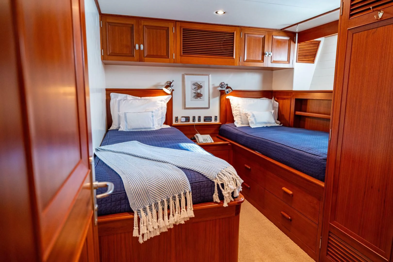 a bedroom with wooden cabinets aboard SEA BOLD Yacht for Sale