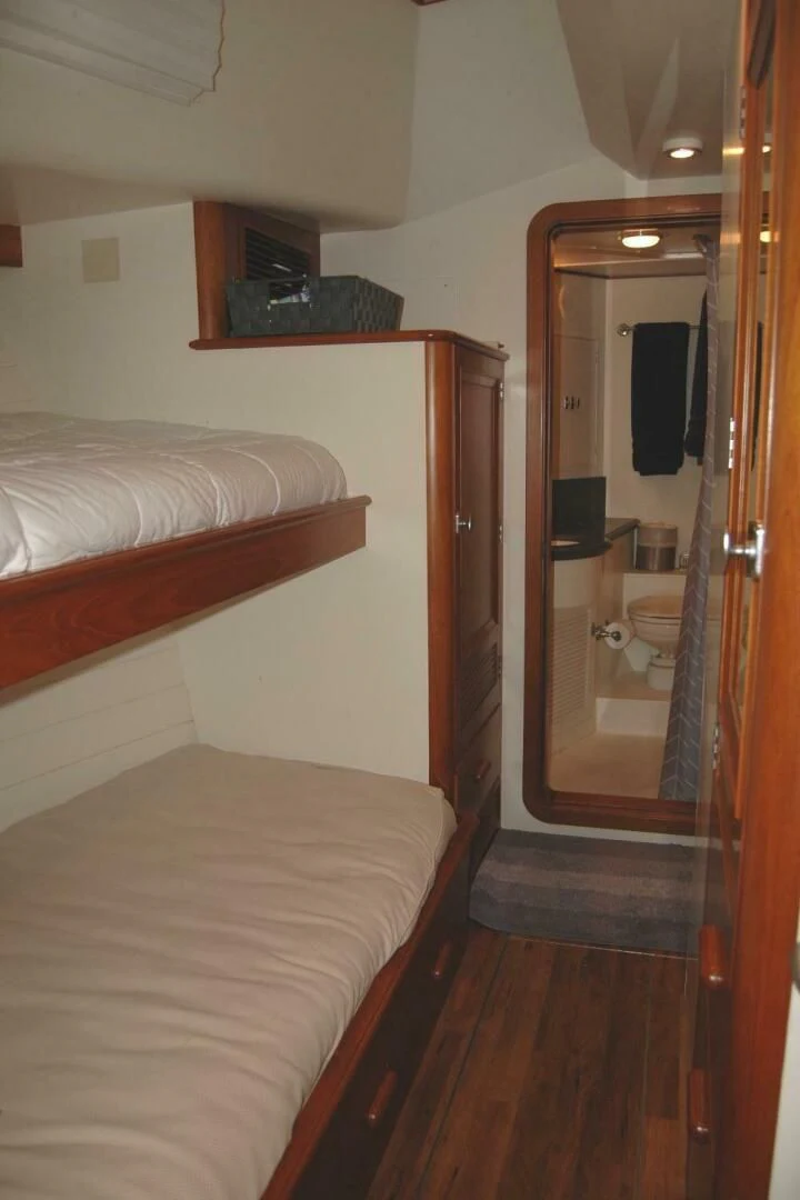 a bedroom with a mirror and a bed aboard SEA BOLD Yacht for Sale