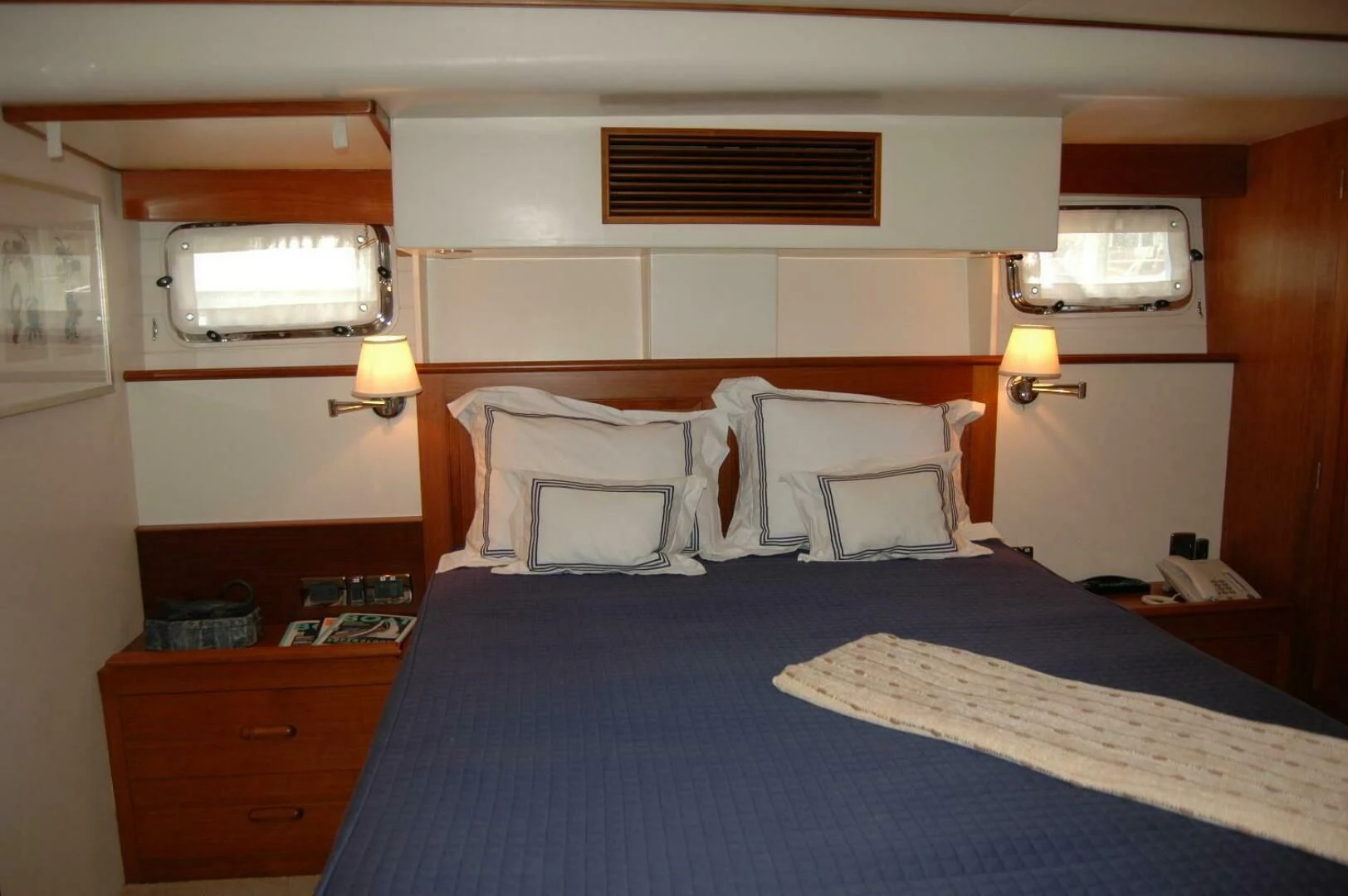 a bed with a blue sheet aboard SEA BOLD Yacht for Sale