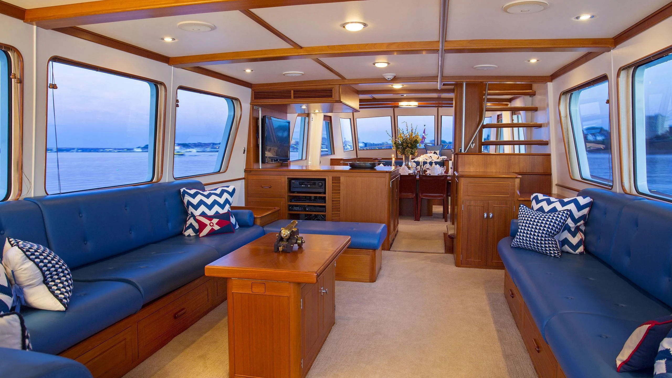 a living room with a blue couch aboard SEA BOLD Yacht for Sale