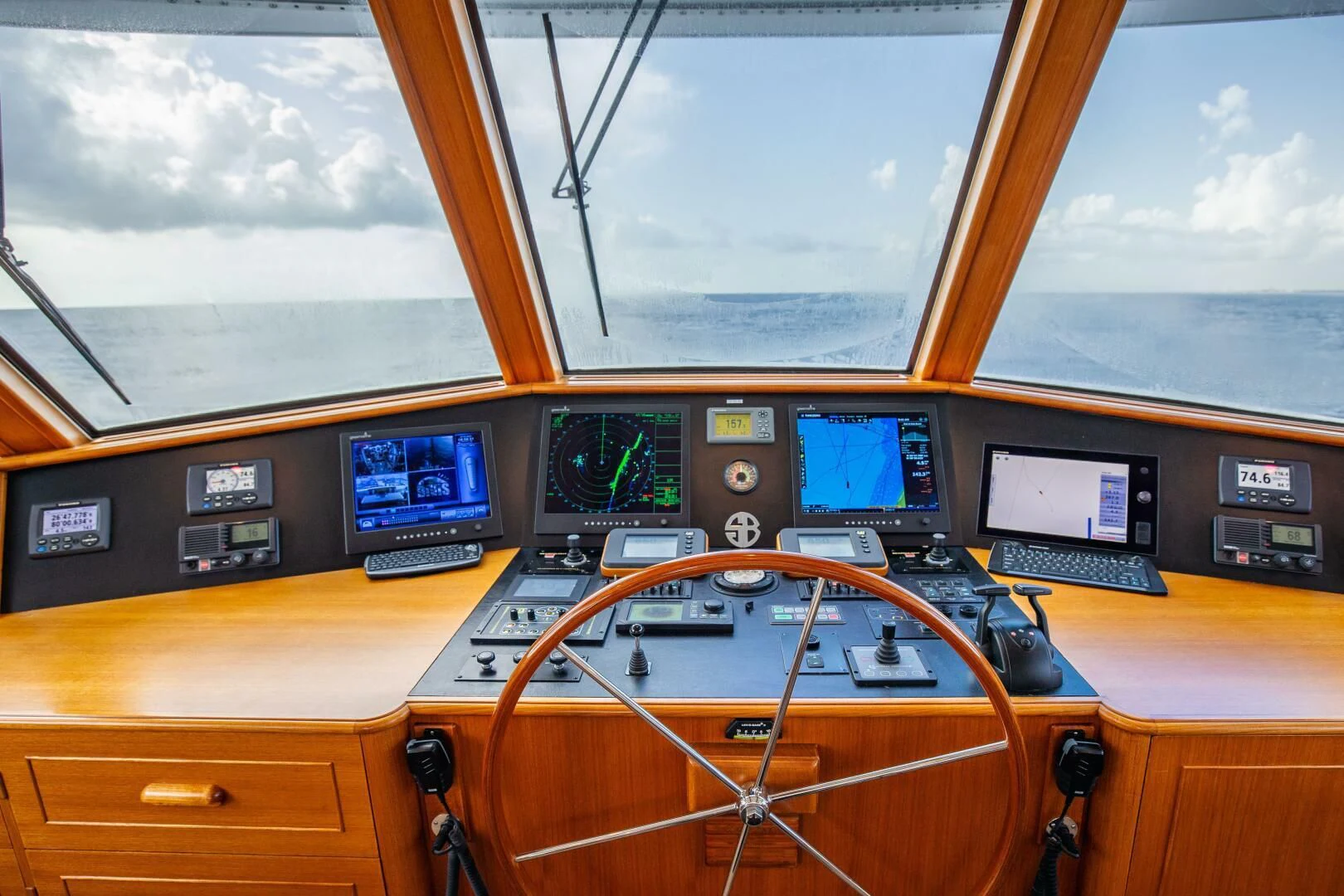a control panel with multiple monitors aboard SEA BOLD Yacht for Sale