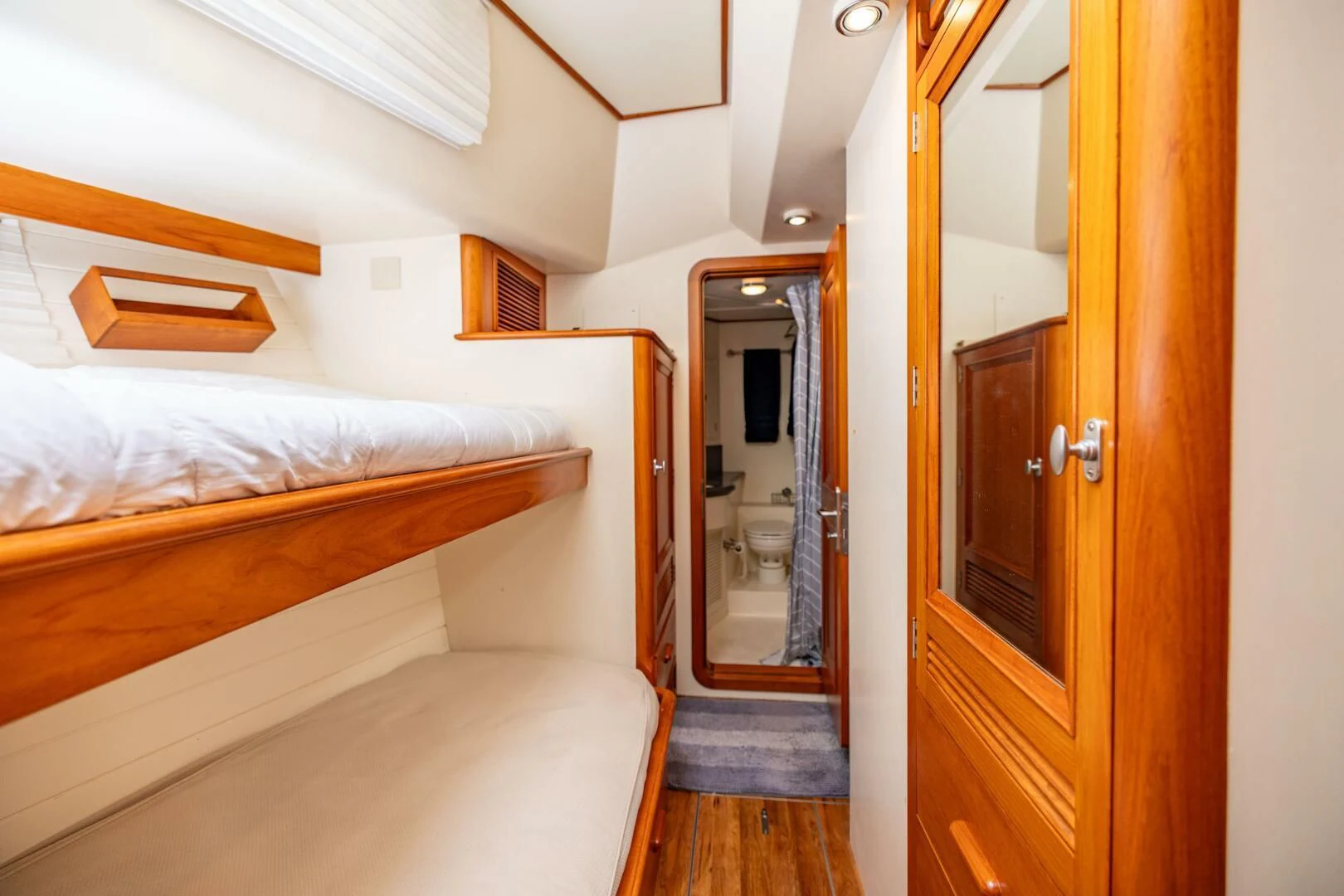 a bedroom with a bed and a mirror aboard SEA BOLD Yacht for Sale