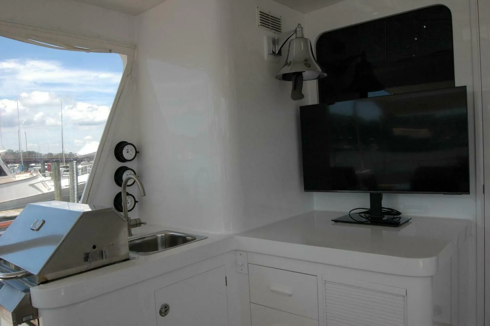 a kitchen with a sink and a tv on the wall aboard SEA BOLD Yacht for Sale