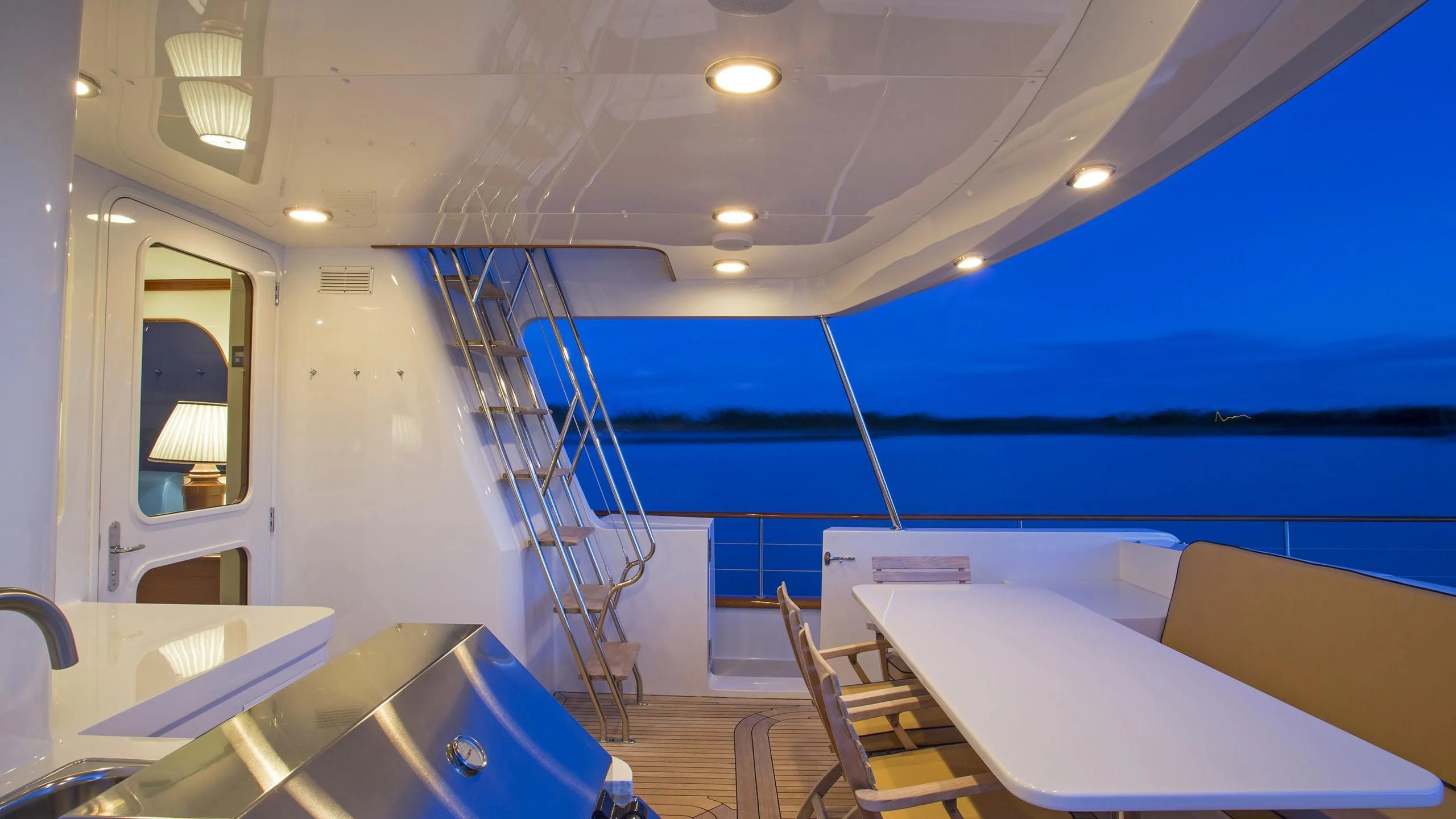 a room with a ladder and a table and chairs aboard SEA BOLD Yacht for Sale