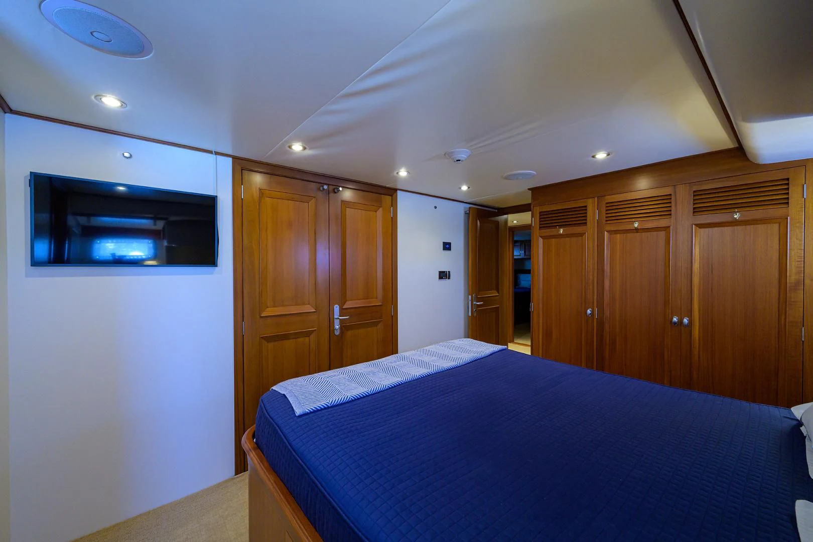a bedroom with a bed and cabinets aboard SEA BOLD Yacht for Sale