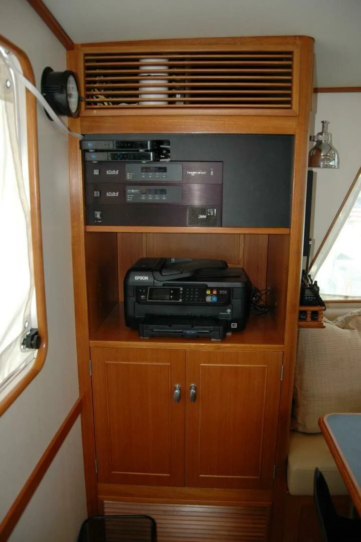 a black printer on a wooden cabinet aboard SEA BOLD Yacht for Sale