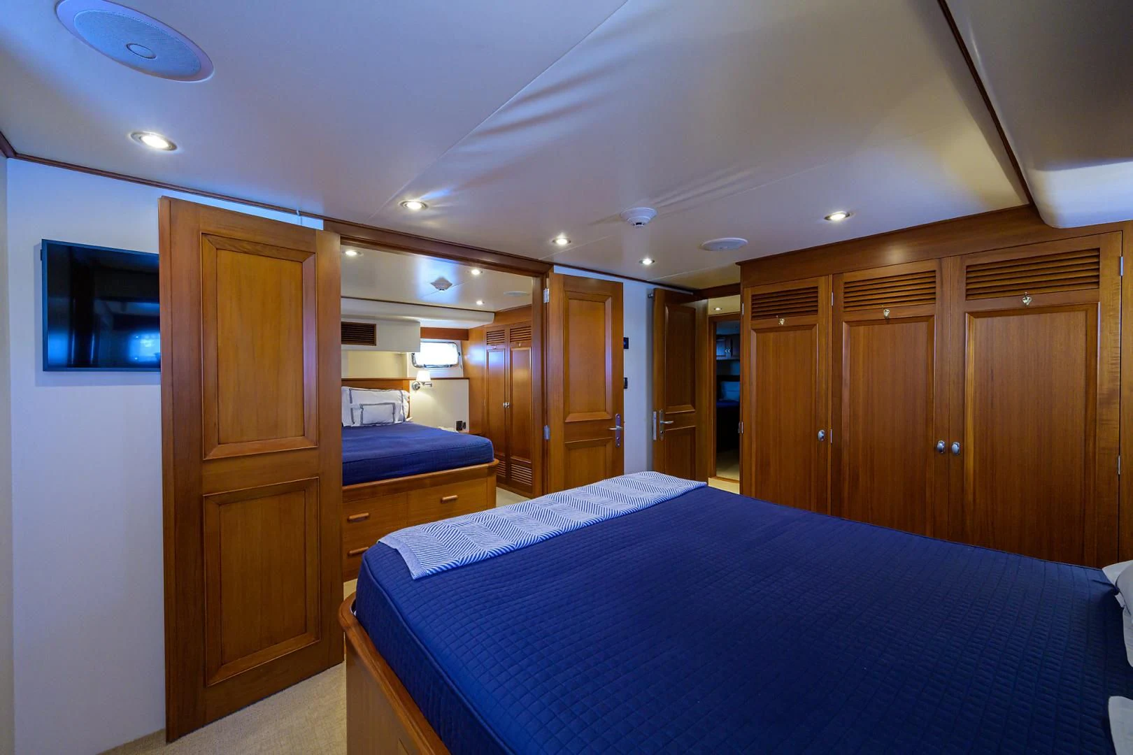 a bedroom with wood cabinets aboard SEA BOLD Yacht for Sale