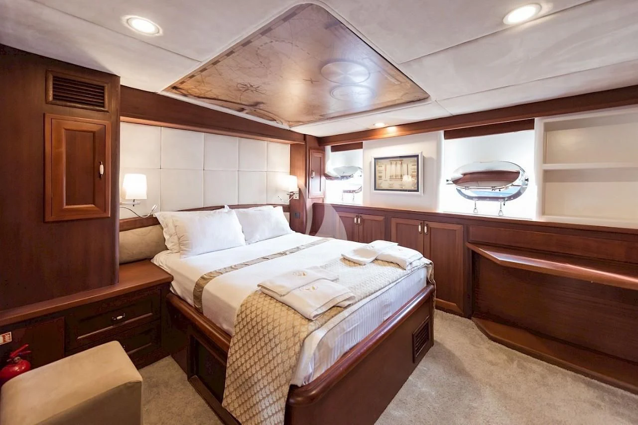 a room with a bed and a fan aboard VIRTUOSO Yacht for Sale