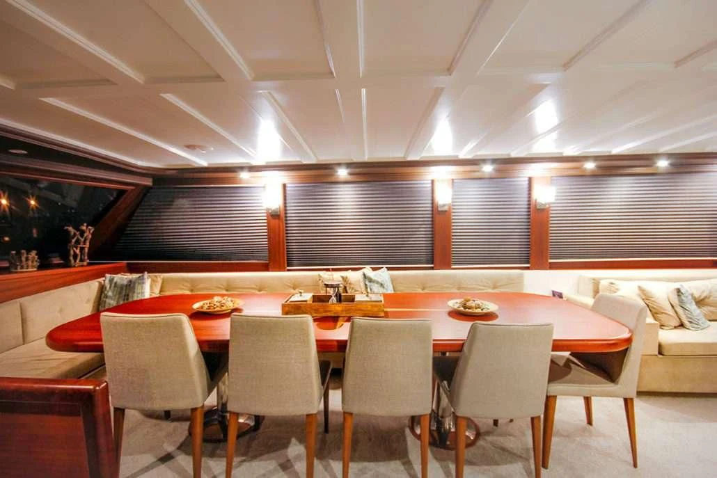 a room with tables and chairs aboard VIRTUOSO Yacht for Sale
