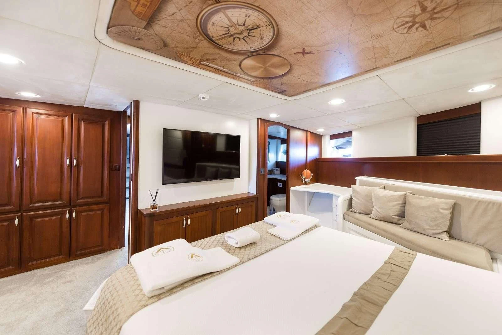 a room with a bed and a television aboard VIRTUOSO Yacht for Sale