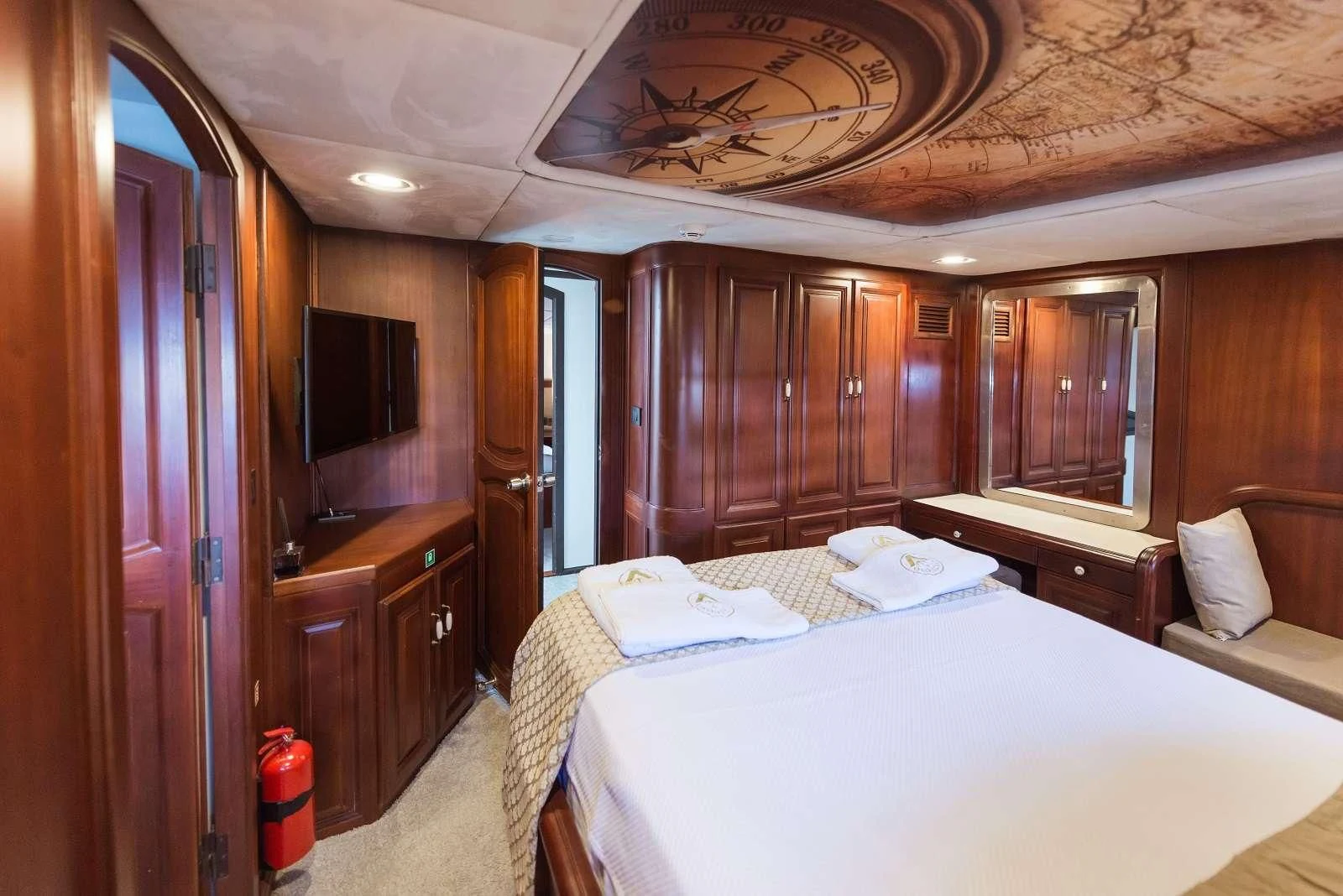 a bedroom with wood cabinets aboard VIRTUOSO Yacht for Sale