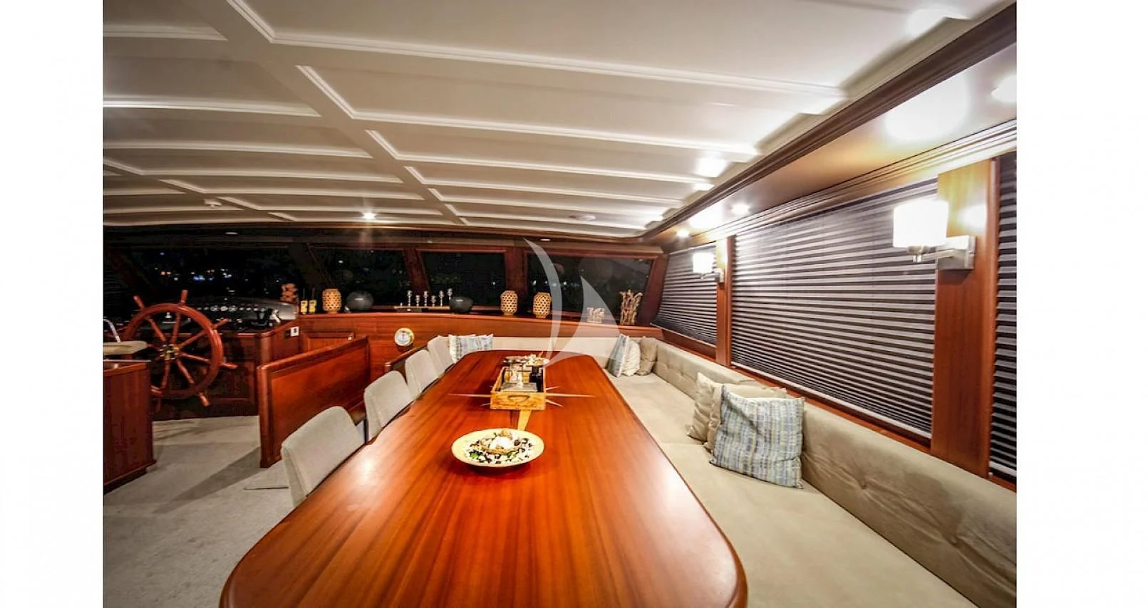 a large room with a table and chairs aboard VIRTUOSO Yacht for Sale