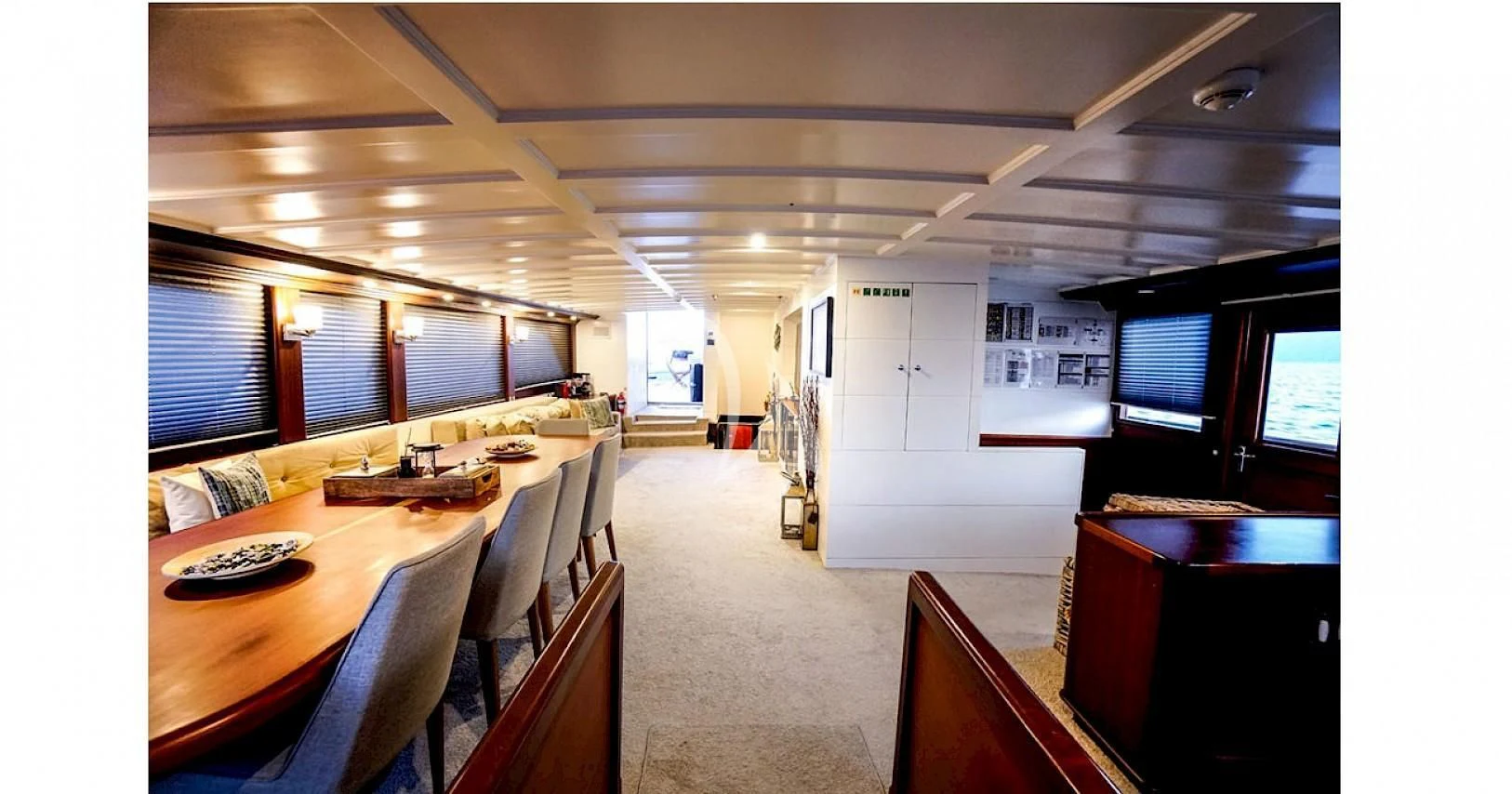 a room with tables and chairs aboard VIRTUOSO Yacht for Sale