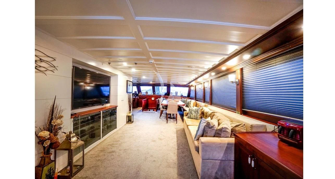 a living room with a couch and a tv aboard VIRTUOSO Yacht for Sale