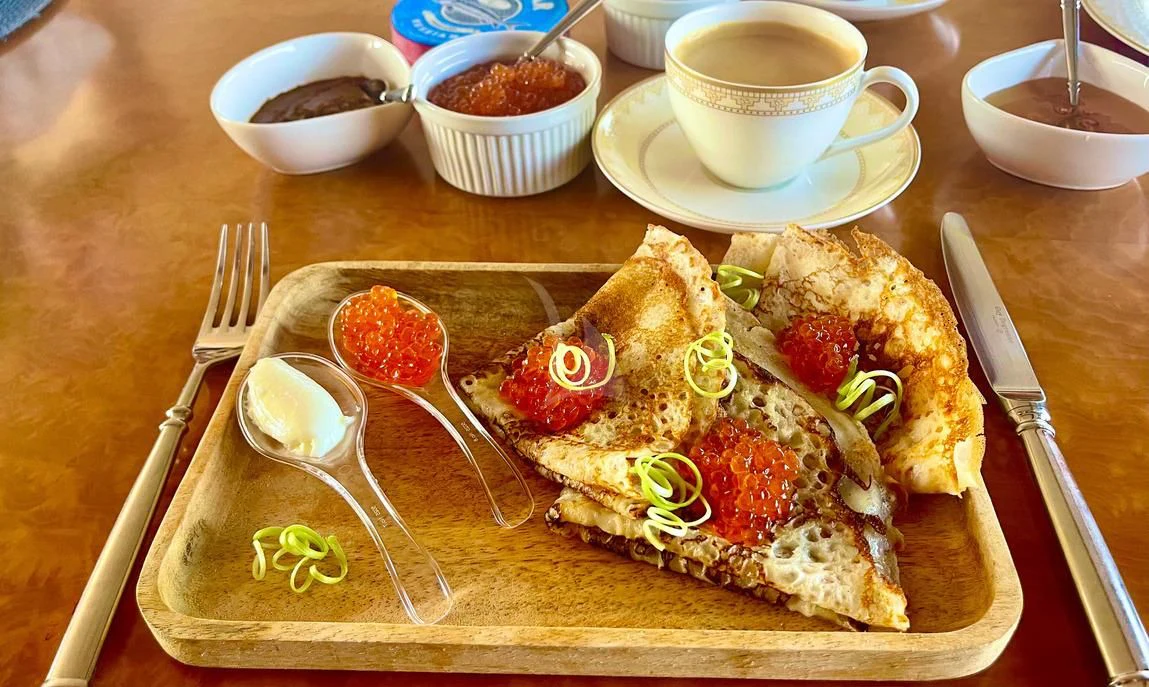 a plate of food and a cup of coffee aboard GALAKTIKA SKAY Yacht for Sale