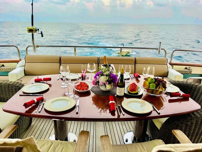a table with food and wine on it aboard GALAKTIKA SKAY Yacht for Sale