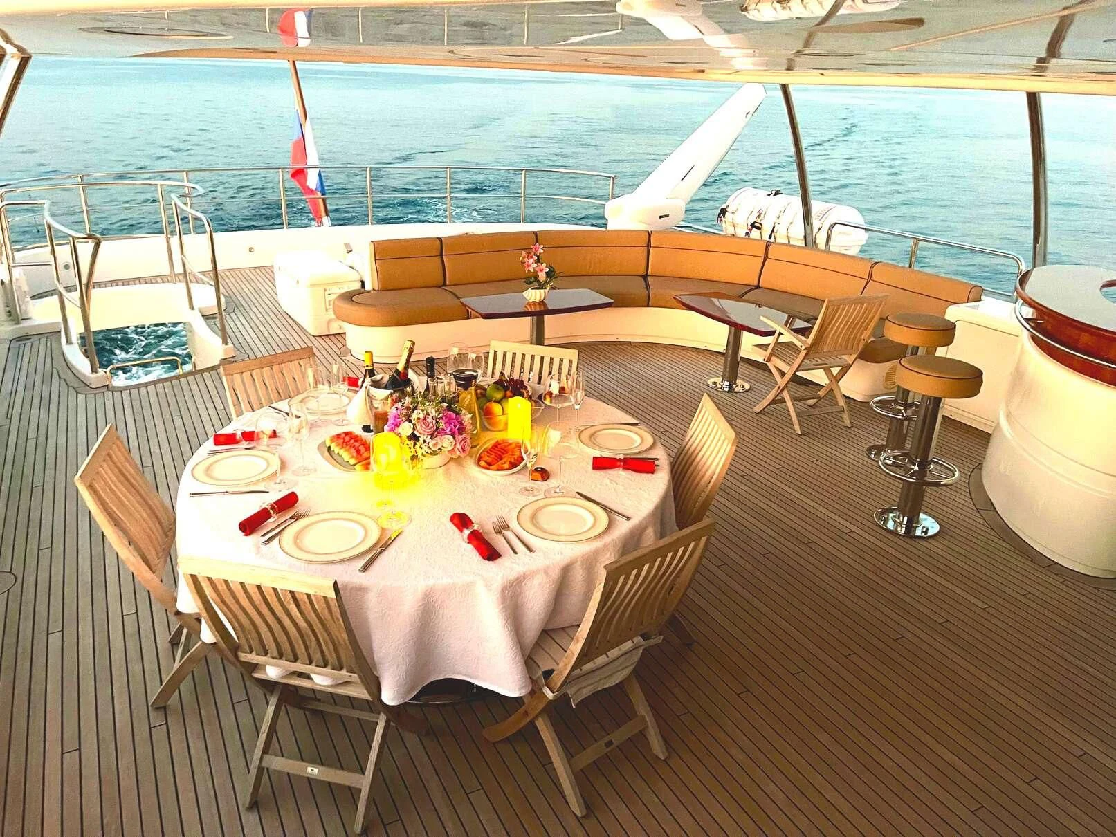 a table set for a meal on a deck overlooking a body of water aboard GALAKTIKA SKAY Yacht for Sale