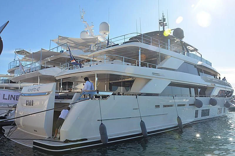 a large white boat with a couple of people on it aboard APRIL Yacht for Sale
