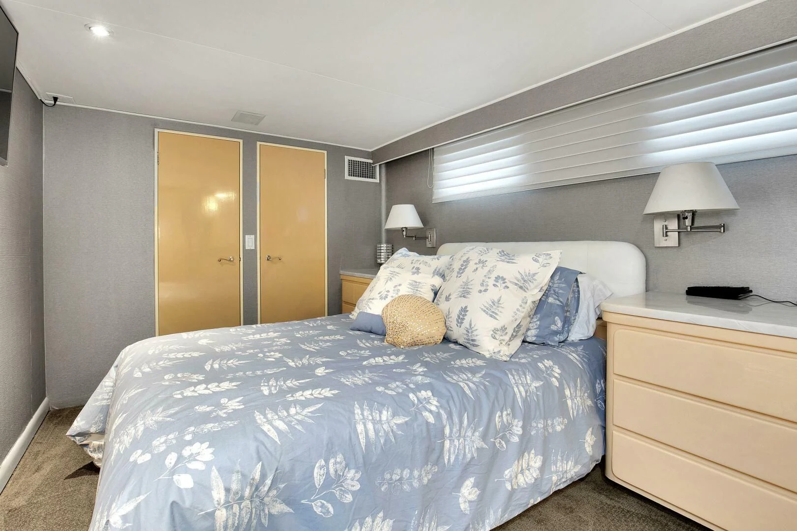 a bedroom with a bed and a desk aboard LADY P Yacht for Sale