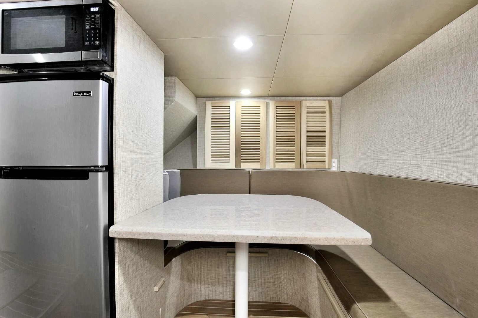 a kitchen with a table and a microwave aboard LADY P Yacht for Sale
