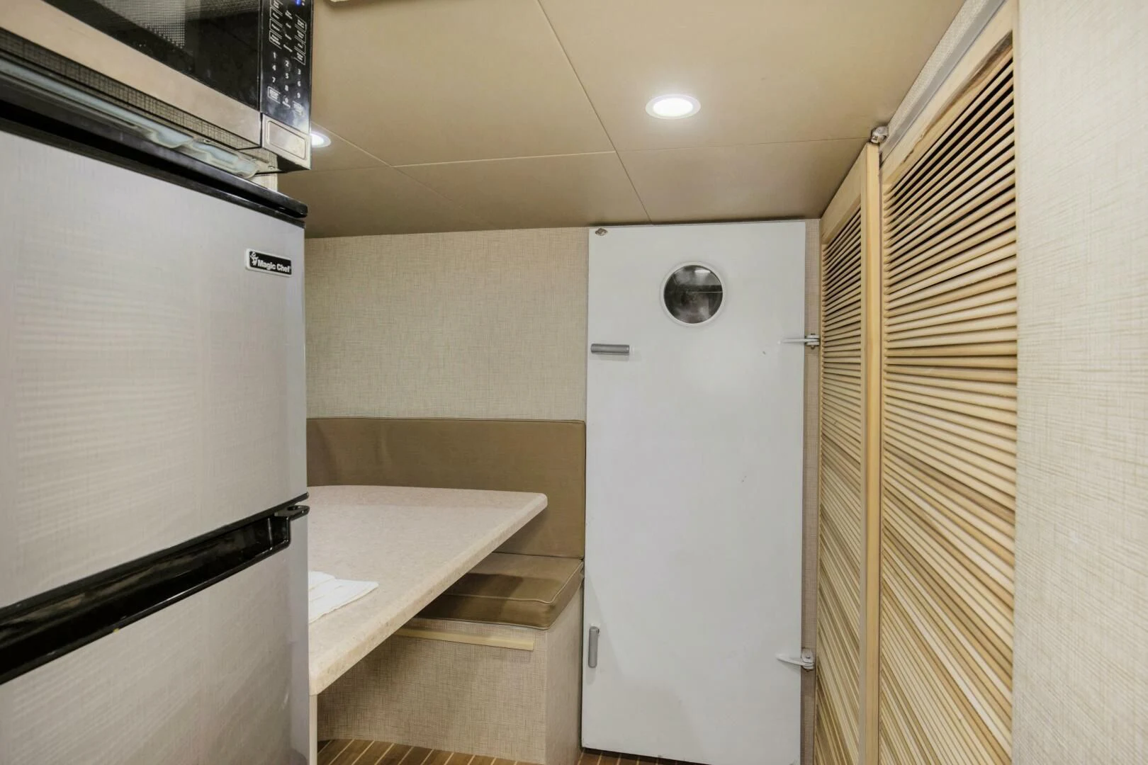 a kitchen with a fridge and a sink aboard LADY P Yacht for Sale