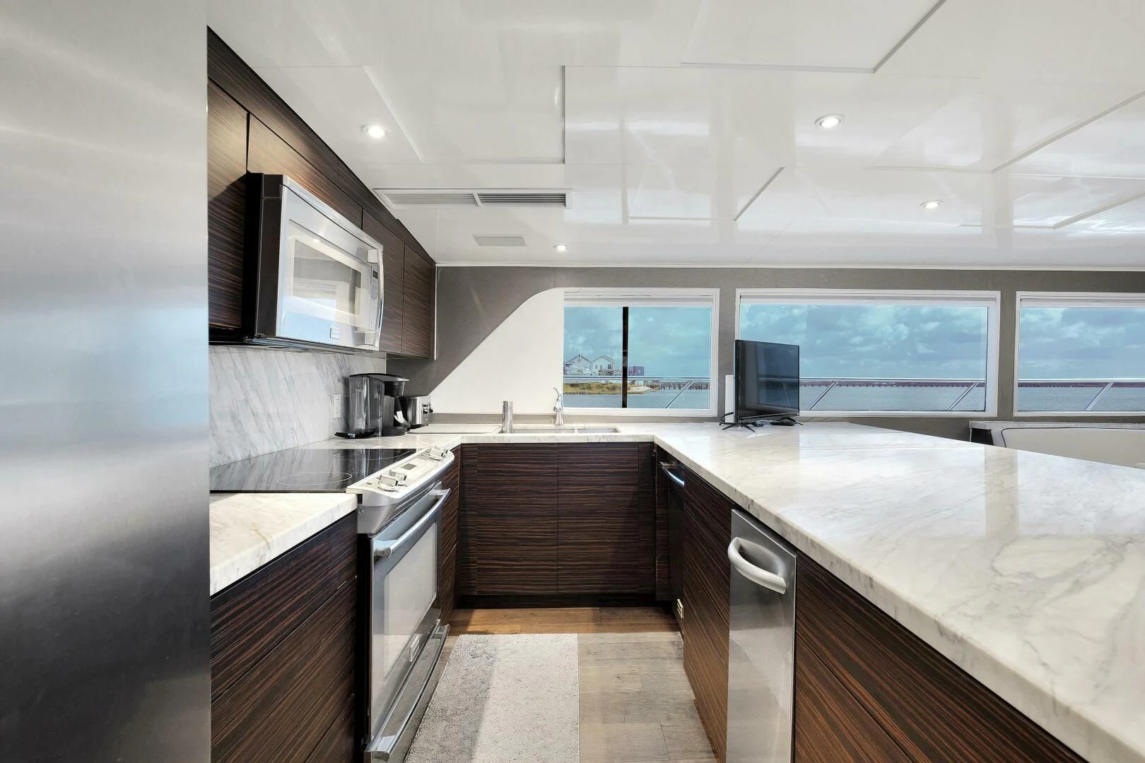 a kitchen with a large island aboard LADY P Yacht for Sale