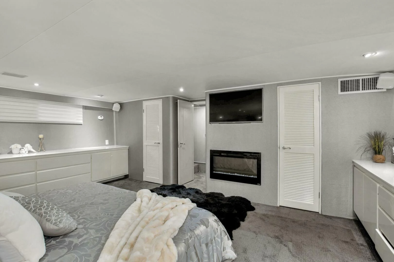 a bedroom with a bed and tv aboard LADY P Yacht for Sale
