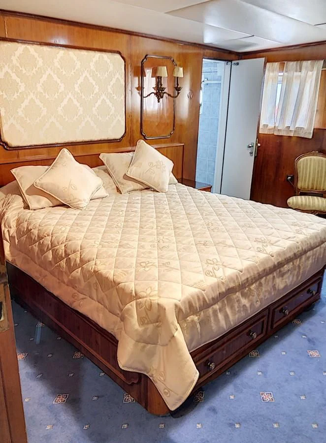 a bed with white sheets aboard ELIKI Yacht for Sale