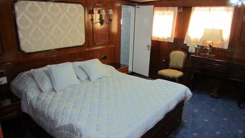 a bed with white sheets aboard ELIKI Yacht for Sale