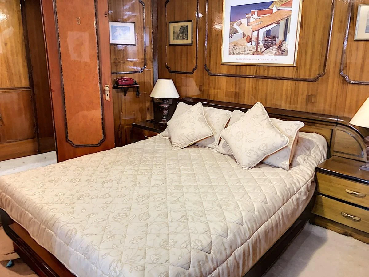 a bed with white sheets aboard ELIKI Yacht for Sale