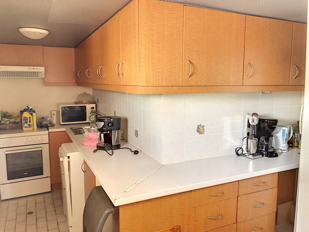 a kitchen with wooden cabinets aboard ELIKI Yacht for Sale