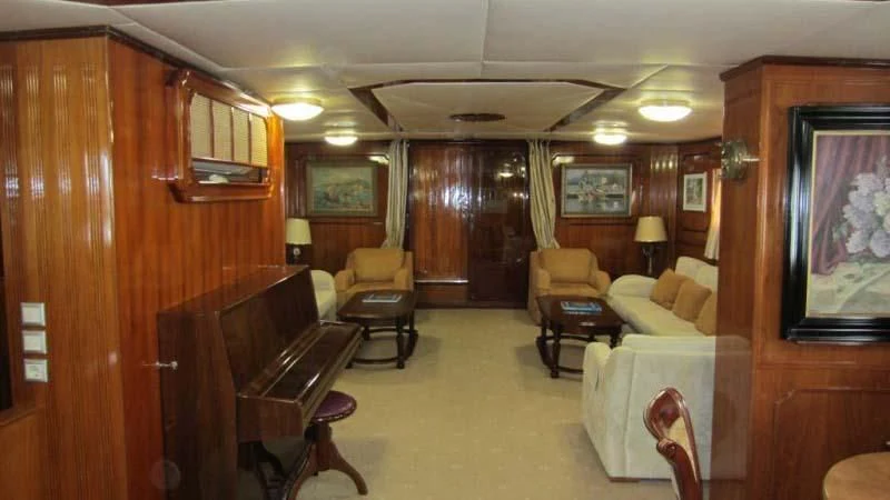 a living room with a piano and a piano aboard ELIKI Yacht for Sale