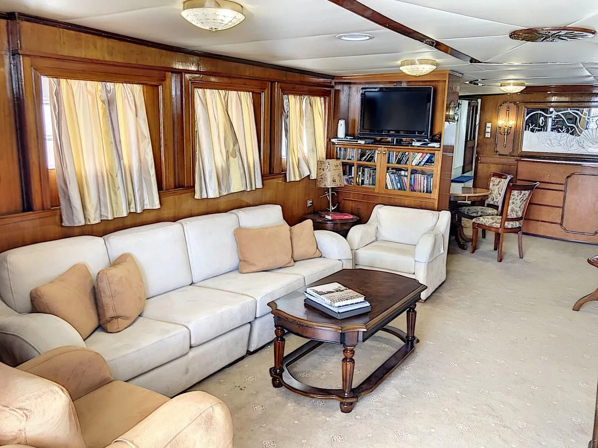 a living room with a couch and a coffee table aboard ELIKI Yacht for Sale