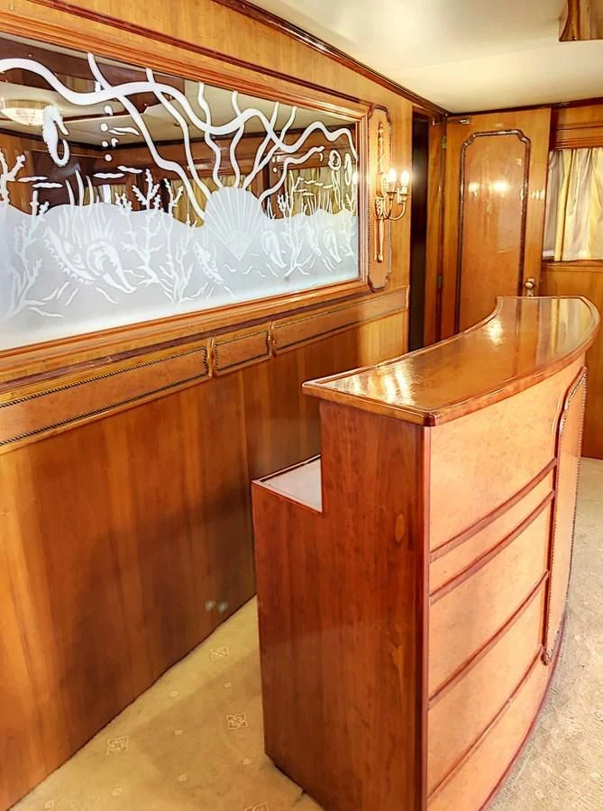 a wooden cabinet with a white curtain aboard ELIKI Yacht for Sale