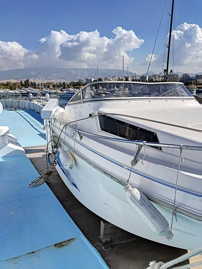 a boat is parked in a harbor aboard ELIKI Yacht for Sale
