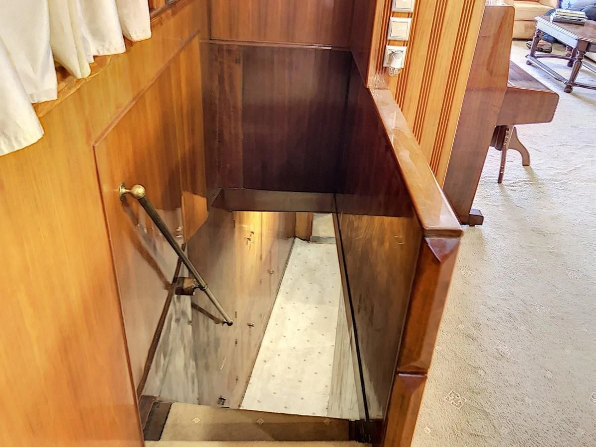 a wooden cabinet with a handle aboard ELIKI Yacht for Sale