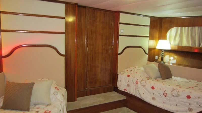 a couple of beds in a room aboard ELIKI Yacht for Sale